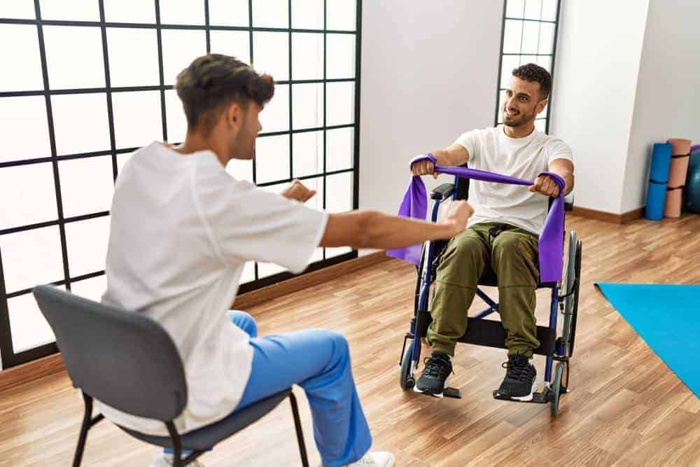 two men working out with physical therapy