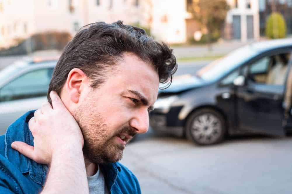 Man holding his neck after a car accident