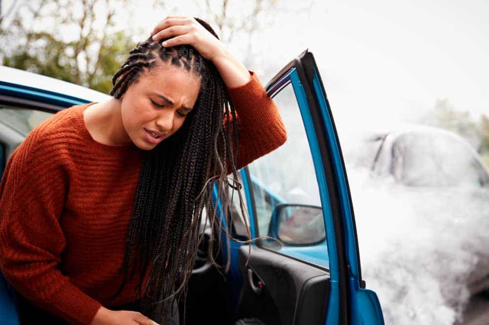 woman in a car accident holding her head