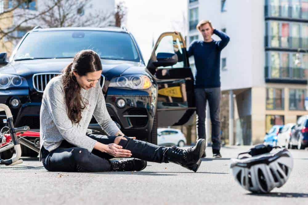 woman holding her leg after a car wreck